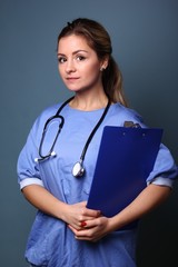 Portrait of a caucasian woman in front of blue background
