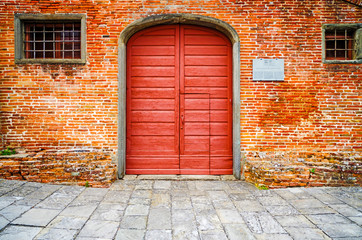 Fototapeta na wymiar Old Red Door in Brick Wall