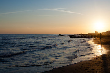 Fototapeta premium Beach at dawn, piers perspective view