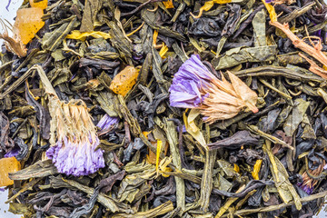 texture of dry black tea with thyme flowers, closeup herbal drink abstraction background