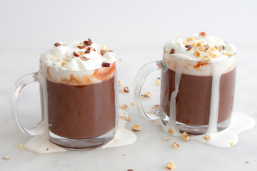 Hot chocolate topped with whipped cream and chopped hazelnuts