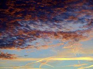 Sky with clouds, sunshine and airline sunset