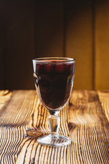 Mulled wine with berries on a rustic wooden table