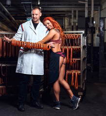 Fototapeta na wymiar Butcher and his sexy girl assistant in the storage room.