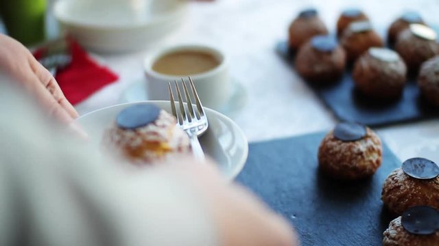 Close up hand man with cup of coffee with sweets or candy chocolates bar obsession candy delicious cocoa dark dessert food milk black brown yummy appetizing beverages bonbon cappuccino