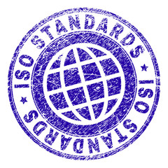 ISO STANDARDS stamp print with grunge effect. Blue vector rubber seal imprint of ISO STANDARDS label with grunge texture. Seal has words arranged by circle and globe symbol.