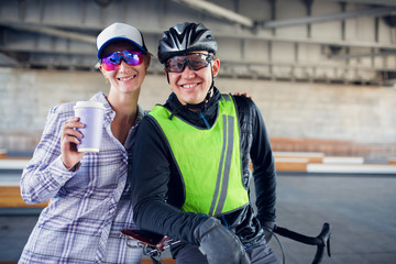 Image of sporty woman and man with bicycle on blurred background