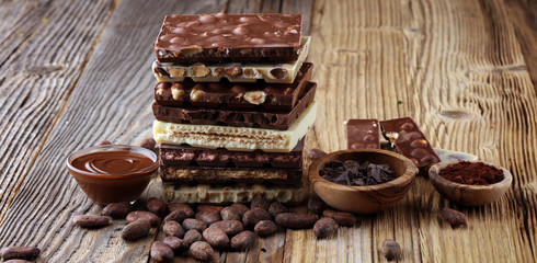 Chocolate bars on table with chocolate tower.