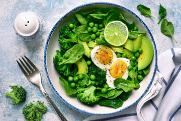 Green vegetable salad with avocado, broccoli, pea and boiled eggs.Top view with copy space.