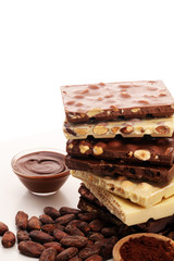 Chocolate bars on table with chocolate tower.