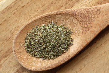 Marjoram on decorative wooden spoon.