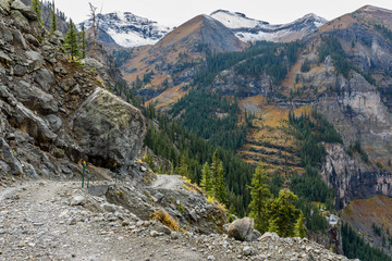 Rugged High Mountain Road - A cloudy autumn day on rugged 4X4 Black Bear Pass trail at side of Ingram Peak, above Bridal Veil Falls and its historic hydroelectric power plant. Telluride, CO, USA. 