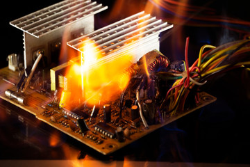 computer power burning, on a black background, close-up, short circuit, electrical equipment...