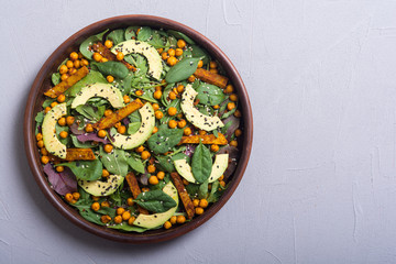 Baby spinach salad with sweet potato , chickpeas and avocado