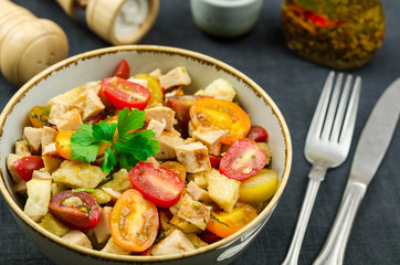 Panzanella salad on a bowl. Panzanella made of roasted ciabatta, red onions, tomatoes and basil. Traditional healthy panzanella salad