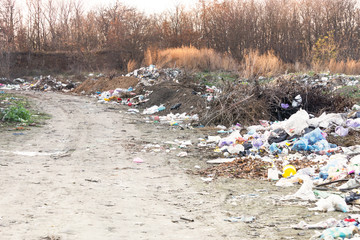 A lot of garbage lying near the road, mountains of garbage, the ecology of the planet