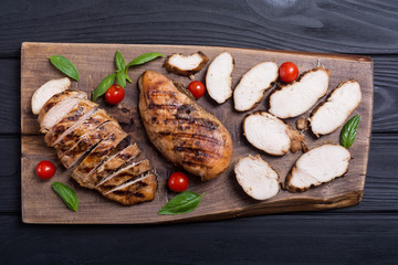 Grilled chicken breast ( fillet ) with basil and tomatoes