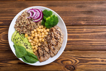 Buddha bowl with broccoli , quinoa , grilled chicken , avocado and spinach