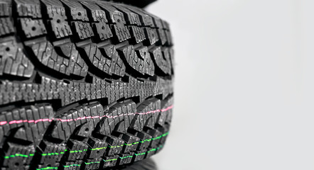 Close-up of a winter tire tread with a strip indicator with copy space a place for text.