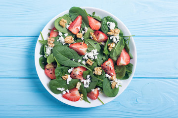 Strawberry salad with spinach , cheese and walnut . Healthy food