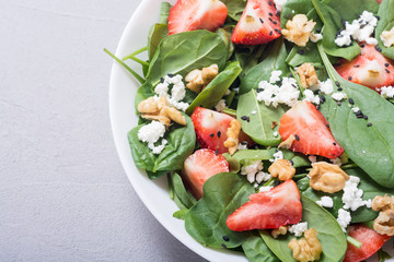 Strawberry salad with spinach , cheese and walnut . Healthy food