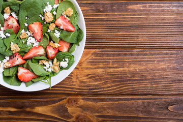 Strawberry salad with spinach , cheese and walnut . Healthy food