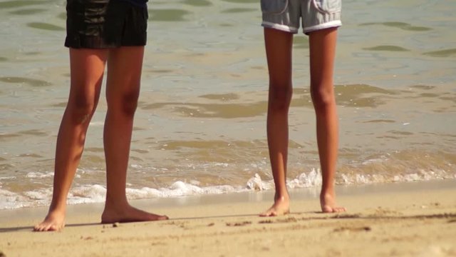 Female Tiny legs standing on white sand beach