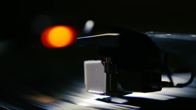 Closeup needle on spinning vintage vinyl record on turntable