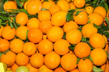 Basket with fresh harvest of oranges on display for sale in a fruit market. Health care and nutrition concept.