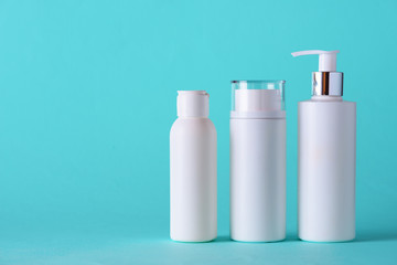 White cosmetic tubes on blue background with copy space. Skin care, body treatment, beauty concept. Banner