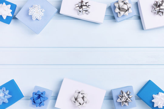 White and blue gift boxes decorated with silver bows. Copy Space. Holiday layout with place for text.