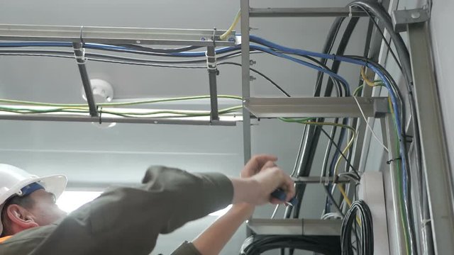 Technicians are installing optic fiber with cable ties.