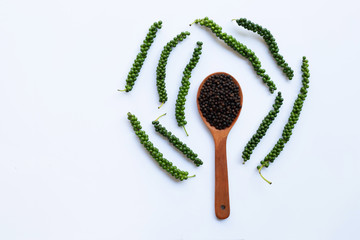 Fresh green peper with Black Pepper on white background.
