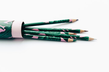 Green pencils on white background