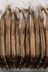 Sea small fish, sprat back up, tightly Packed in a glass container, vertical.