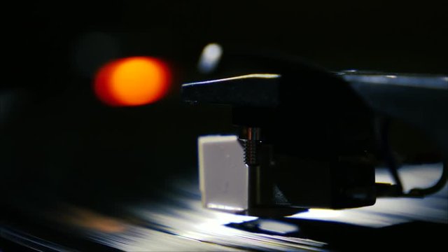 Closeup needle on spinning vintage vinyl record on turntable