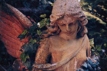 Beautiful sad angel. Vintage styled image of ancient statue. Fragment of sculpture. Retro styled.