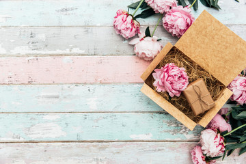 peonies and gift box on wooden table © victoria