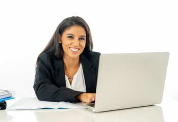 Portrait of attractive young businesswoman working on her laptop looking happy and confident