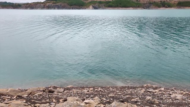 Autumn leaves, blue water lake and snowy mountains, stuff dreams are made of. 
Lake Serre Pon&radic;&szlig;on in south east France (Hautes Alpes).