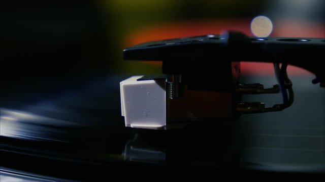 Closeup needle on spinning vintage vinyl record on turntable