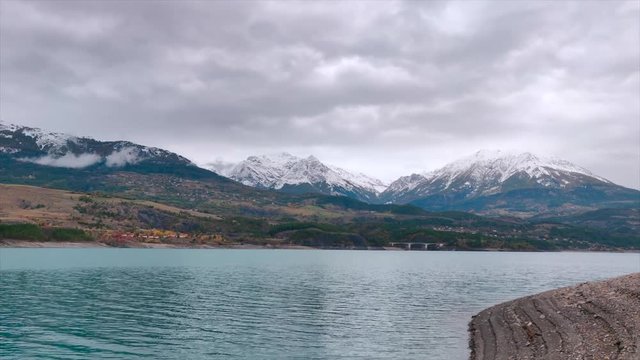 Autumn leaves, blue water lake and snowy mountains, stuff dreams are made of. 
Lake Serre Pon&radic;&szlig;on in south east France (Hautes Alpes).