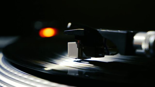 Closeup needle on spinning vintage vinyl record on turntable