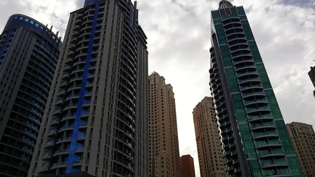 Dubai Marina Skyscrapers Buildings Towers Yachts Moschee Construction Sites Cloudy Day Time View From Boat