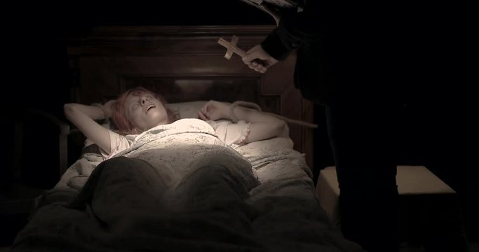 the priest with the cross do an exorcism the obsessed girl