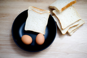 Homemade breads or bun on wood background, egg, breakfast food