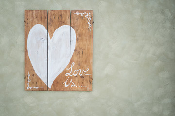 White heart painte on wood with grey bacground