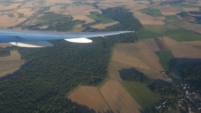 Passenger view from commercial jet. Banking over countryside of rural France. Preparing to land at Charles de Gaulle airport.