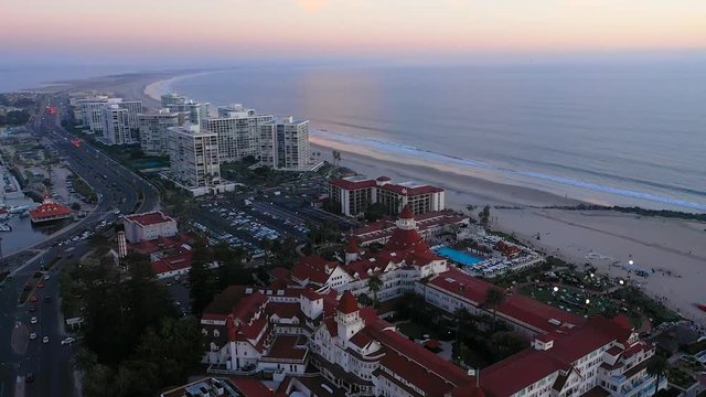 Aerial view of Hotel Del Coronado, Coronado Beach, and the Silver Stand during sunset