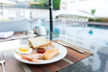 Delicious Breakfast set by the swimming pool at Pattaya, Thailand